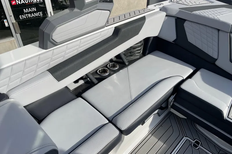 Slide: The Image of 2024 Nautique Super Air Nautique G23 interior seating with cup holders and modern design. - 7