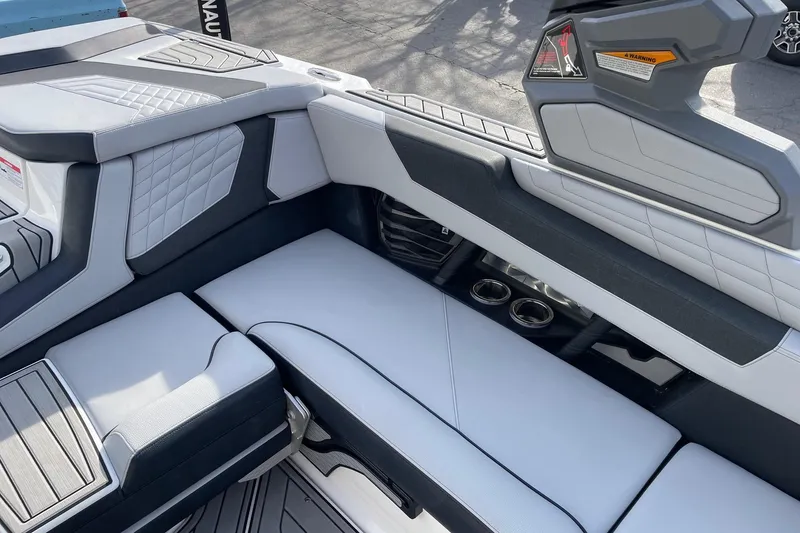 Slide: The Image of 2024 Nautique Super Air Nautique G23 interior seating with modern design and cup holders. - 9