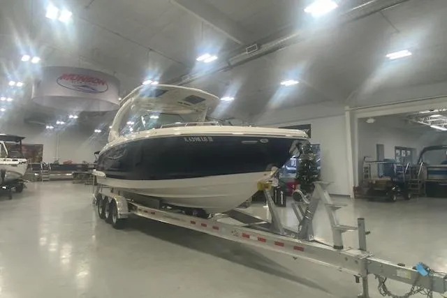 Slide: The Image of 2023 Chaparral 307 SSX boat on trailer in showroom. - 12