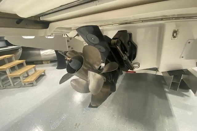 Slide: The Image of 2023 Chaparral 307 SSX boat propeller and stern drive in a showroom. - 18