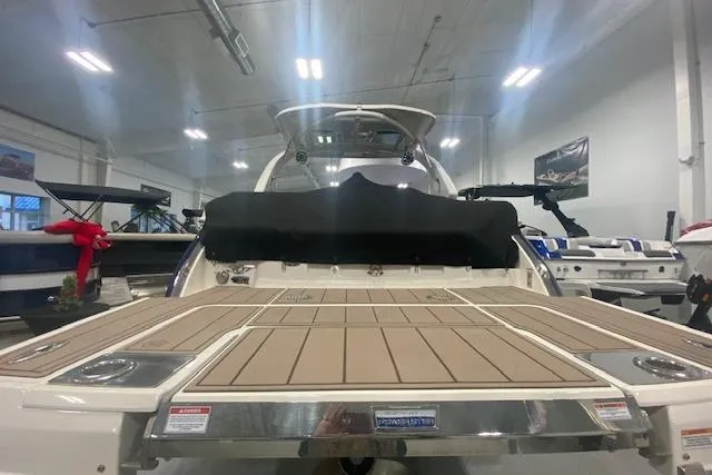 Slide: The Image of 2023 Chaparral 307 SSX boat in showroom, rear view with swim platform. - 19