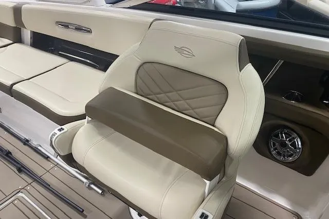 Slide: The Image of Luxurious seating in 2023 Chaparral 307 SSX boat, featuring beige and brown upholstery. - 28