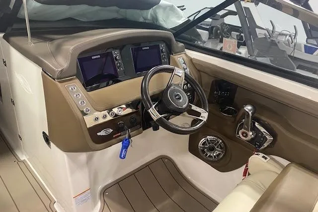 Slide: The Image of 2023 Chaparral 307 SSX boat cockpit with dual displays and steering wheel. - 31