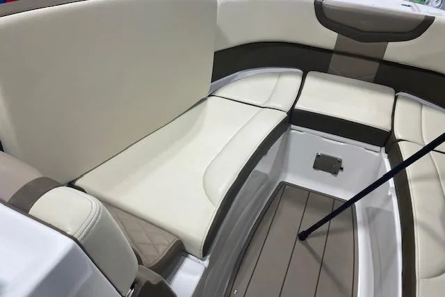 Slide: The Image of 2023 Chaparral 307 SSX boat interior with beige and brown seating. - 35