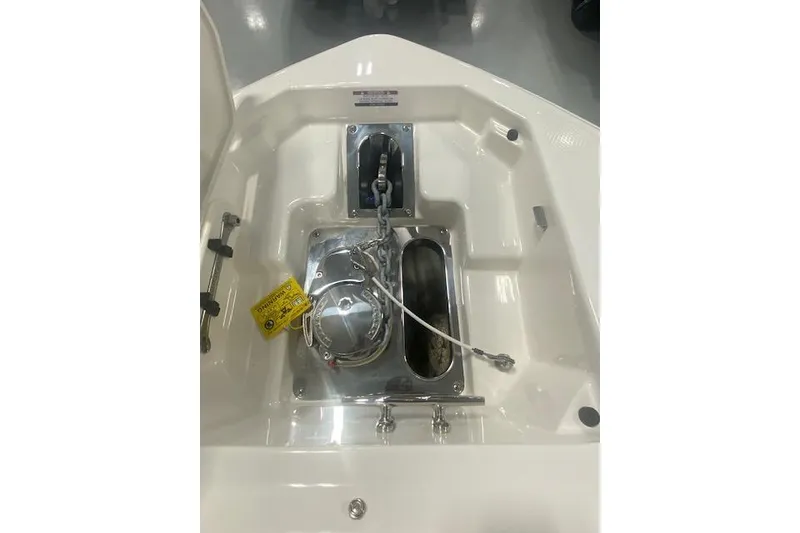 Slide: The Image of 2023 Chaparral 307 SSX boat anchor compartment with chain and winch. - 37