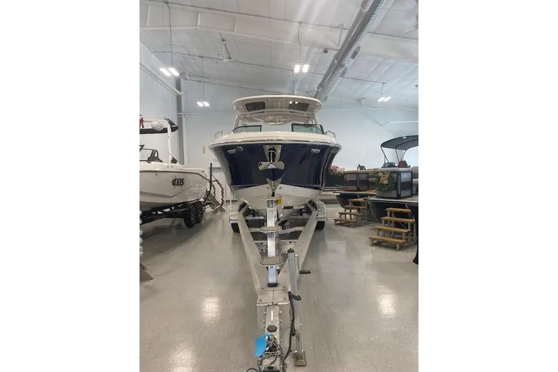 Slide: The Image of 2023 Chaparral 307 SSX boat displayed indoors on a trailer. - 39