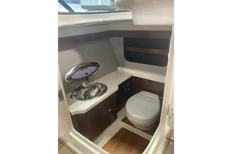Slide: The Image of 2023 Chaparral 307 SSX boat interior bathroom with sink and toilet. - 42