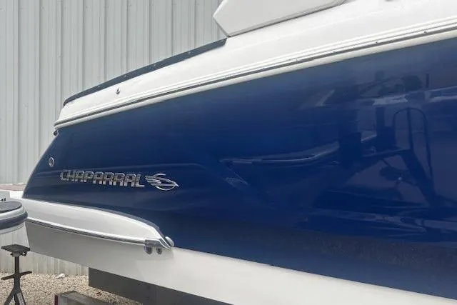 Slide: The Image of 2023 Chaparral 307 SSX boat with sleek blue and white exterior design. - 47