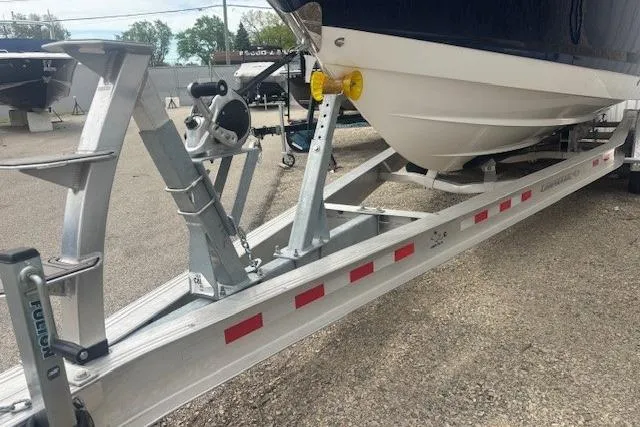 Slide: The Image of 2023 Chaparral 307 SSX boat on a trailer, showcasing hull and trailer details. - 51