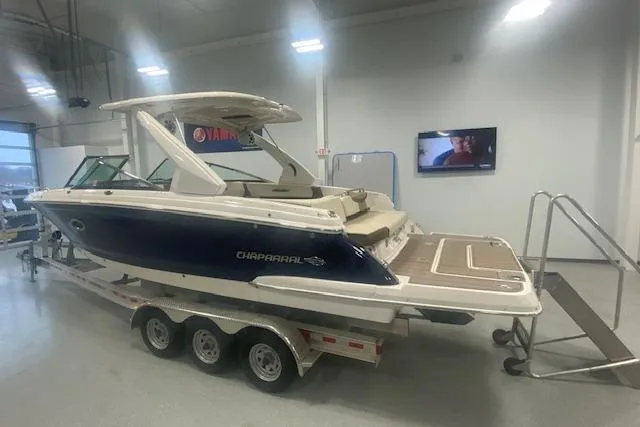 Slide: The Image of 2023 Chaparral 307 SSX boat on trailer in showroom, side view. - 6