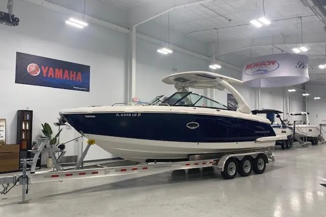 Slide: The Image of 2023 Chaparral 307 SSX boat on trailer in showroom with Yamaha signage. - 8