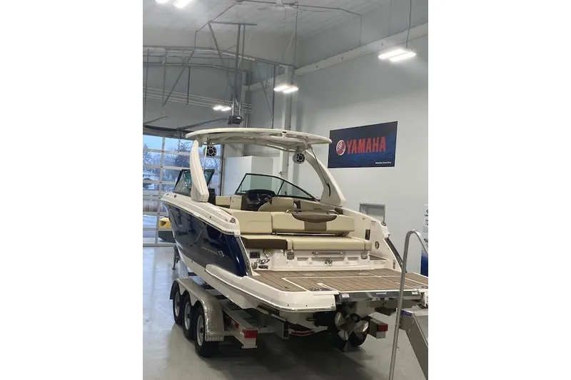 Slide: The Image of 2023 Chaparral 307 SSX boat in showroom, rear view, on trailer. - 9