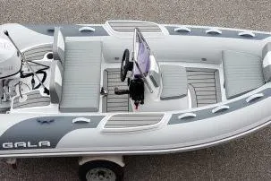 Slide: The Image of 2026 Gala Viking V330 boat with Tohatsu 30HP engine, top view, gray and white design. - 12