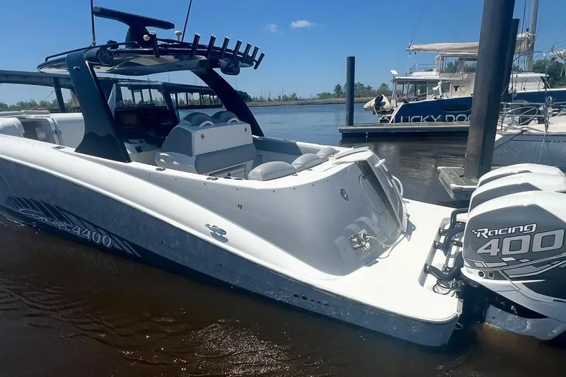 The Image of 2010 Concept 4400 Sport Yacht on calm water near waterfront homes. - 2