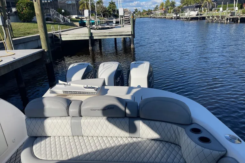 Slide: The Image of 2010 Concept 4400 Sport Yacht docked by a scenic waterfront with palm trees. - 21