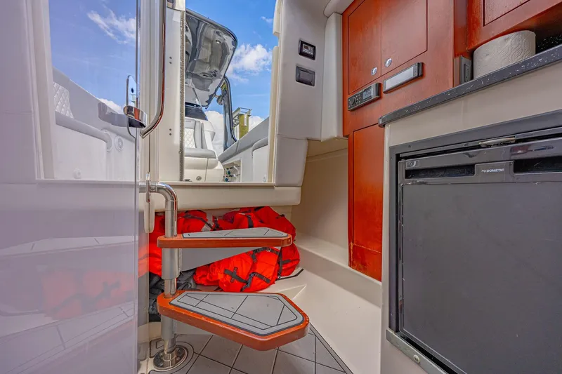 Slide: The Image of Interior of 2010 Concept 4400 Sport Yacht with life jackets and compact kitchen area. - 23