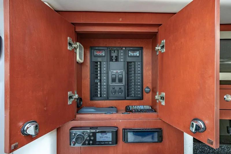 Slide: The Image of Electrical control panel inside 2010 Concept 4400 Sport Yacht with wooden cabinet doors open. - 33