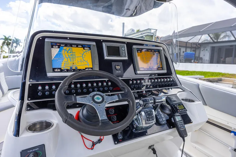 Slide: The Image of Control panel of a 2010 Concept 4400 Sport Yacht with navigation screens and steering wheel. - 47