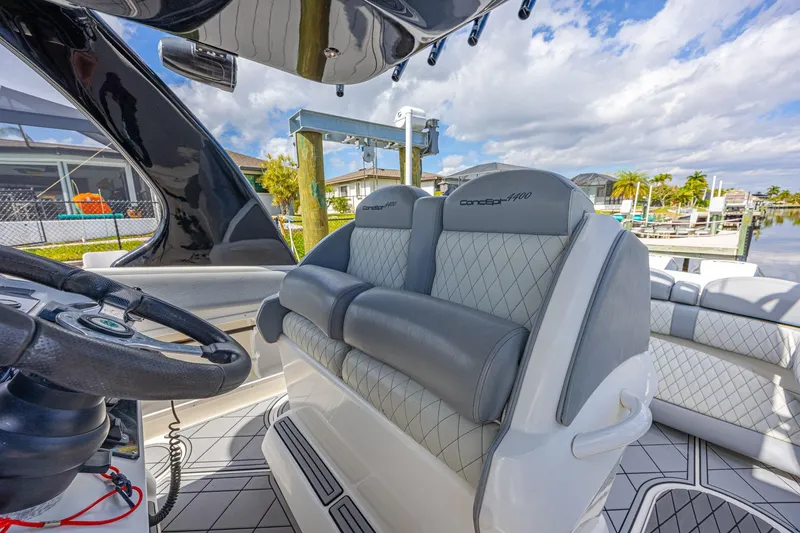 Slide: The Image of 2010 Concept 4400 Sport Yacht interior with luxurious seating and modern steering wheel. - 54