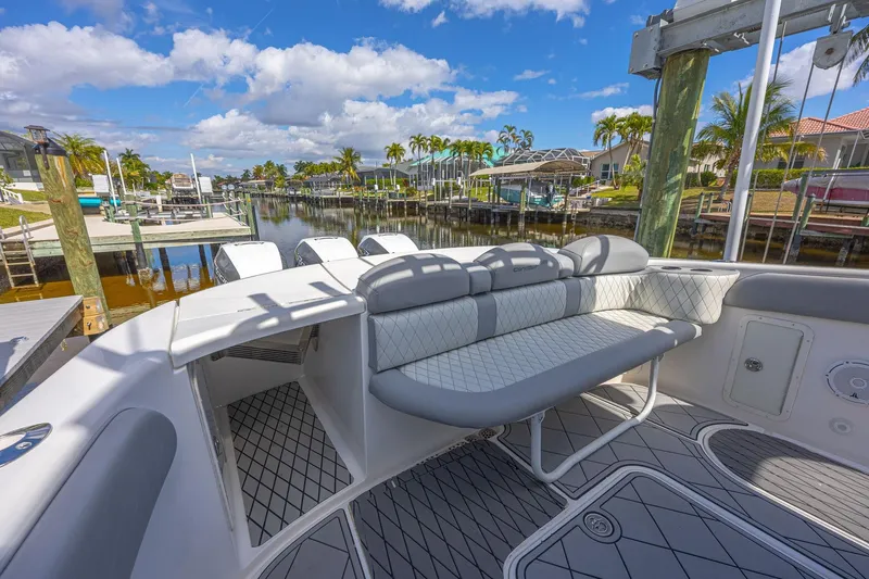 Slide: The Image of 2010 Concept 4400 Sport Yacht with elegant seating, docked in a scenic marina. - 60