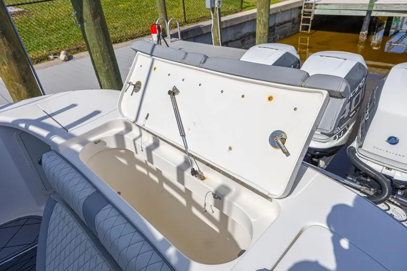 Slide: The Image of Open storage compartment on 2010 Concept 4400 Sport Yacht, docked with visible outboard engines. - 63