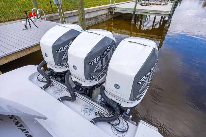 Slide: The Image of Triple outboard engines on a 2010 Concept 4400 Sport Yacht docked by the water. - 73