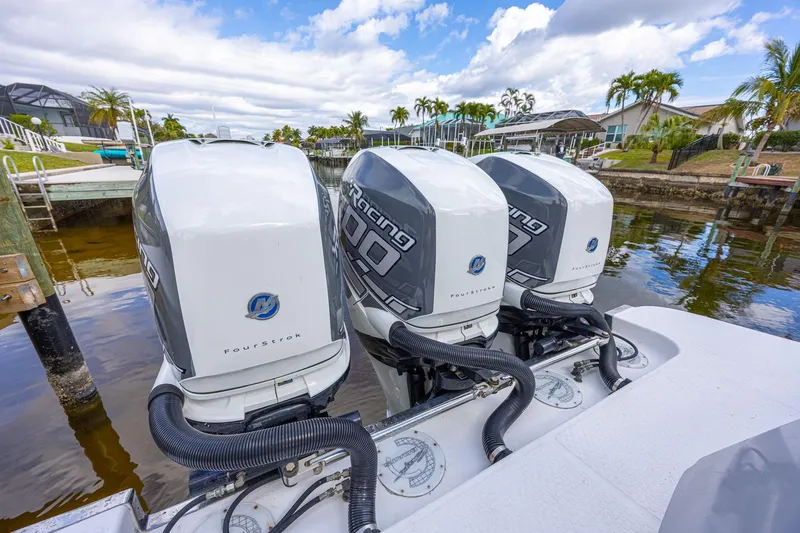 Slide: The Image of Triple outboard motors on a 2010 Concept 4400 Sport Yacht, docked by a canal. - 74