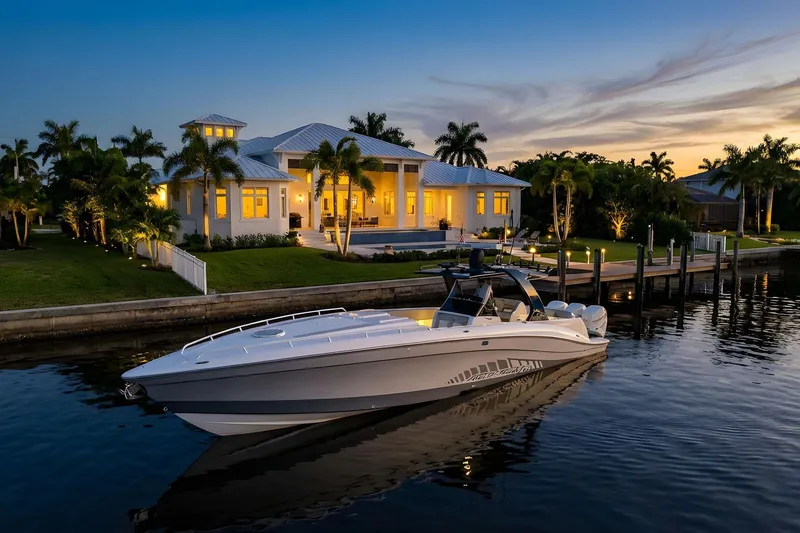 Slide: The Image of Luxurious 2010 Concept 4400 Sport Yacht docked by elegant waterfront home at sunset. - 76