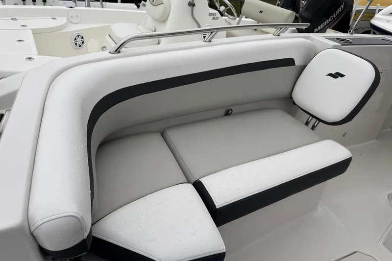 Slide: The Image of 2024 Starcraft SVX 211 OB boat interior seating with sleek white and black upholstery. - 4