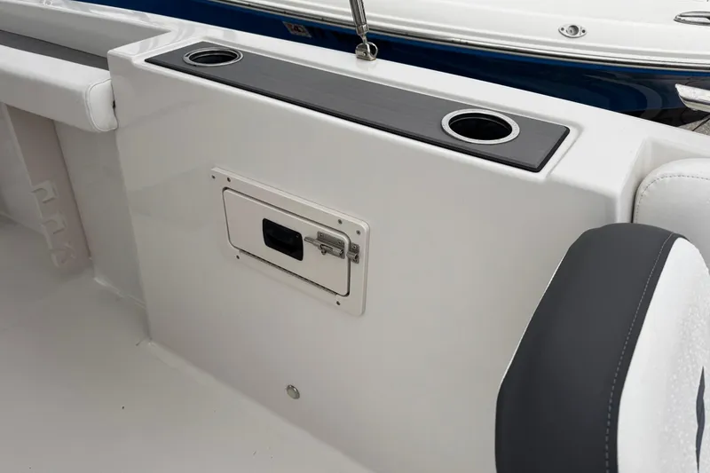 Slide: The Image of 2024 Starcraft SVX 211 OB boat interior with cup holders and storage compartment. - 5