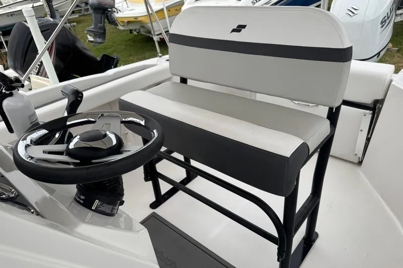 Slide: The Image of 2024 Starcraft SVX 211 OB boat interior with steering wheel and seating. - 7
