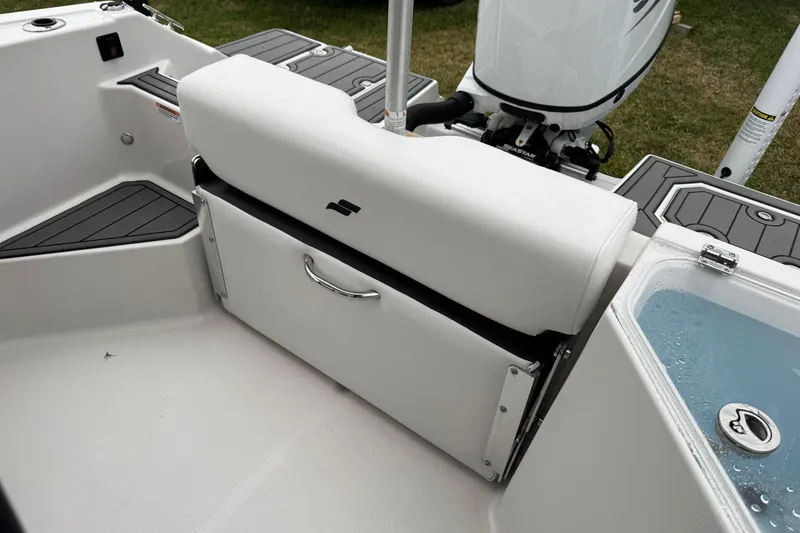 Slide: The Image of 2024 Starcraft SVX 211 OB boat interior with cushioned seating and storage. - 8