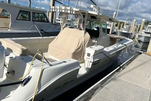 Slide: The Image of 2018 Hydra-Sports 3000 CC boat docked at marina under cloudy sky. - 12