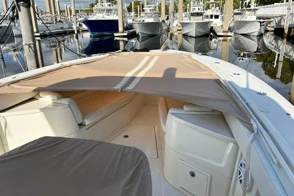 Slide: The Image of 2018 Hydra-Sports 3000 CC boat docked, featuring covered seating area and sleek design. - 2