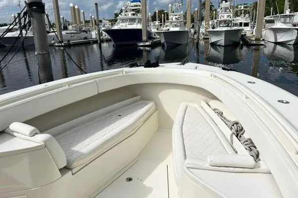 Slide: The Image of 2018 Hydra-Sports 3000 CC boat with cushioned seating, docked at a marina. - 3