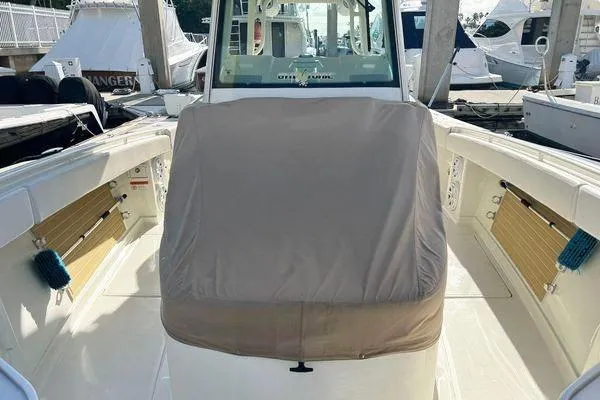 Slide: The Image of 2018 Hydra-Sports 3000 CC boat interior with covered console, docked at marina. - 4