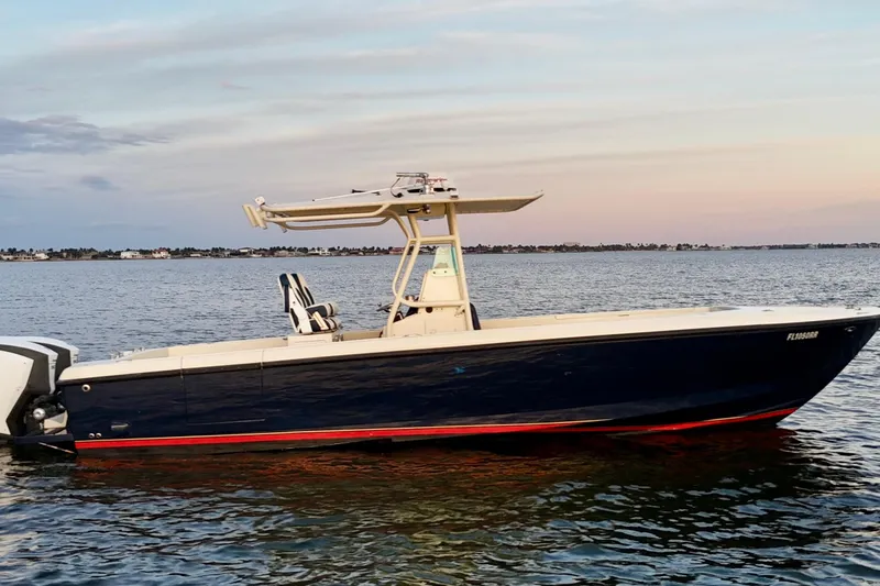 Slide: The Image of 2003 Intrepid 289 Center Console boat on calm water at sunset. - 10