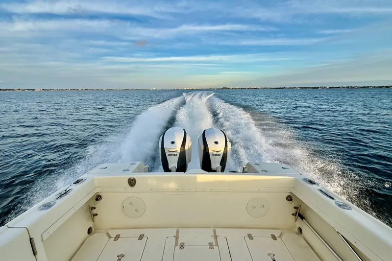 Slide: The Image of 2003 Intrepid 289 Center Console boat cruising on open water, twin engines visible. - 13