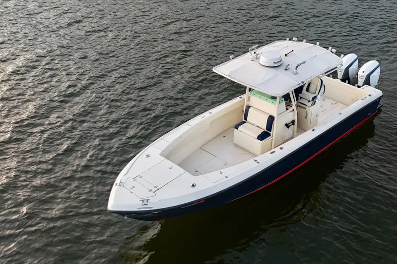 Slide: The Image of 2003 Intrepid 289 Center Console boat on calm water, aerial view. - 14