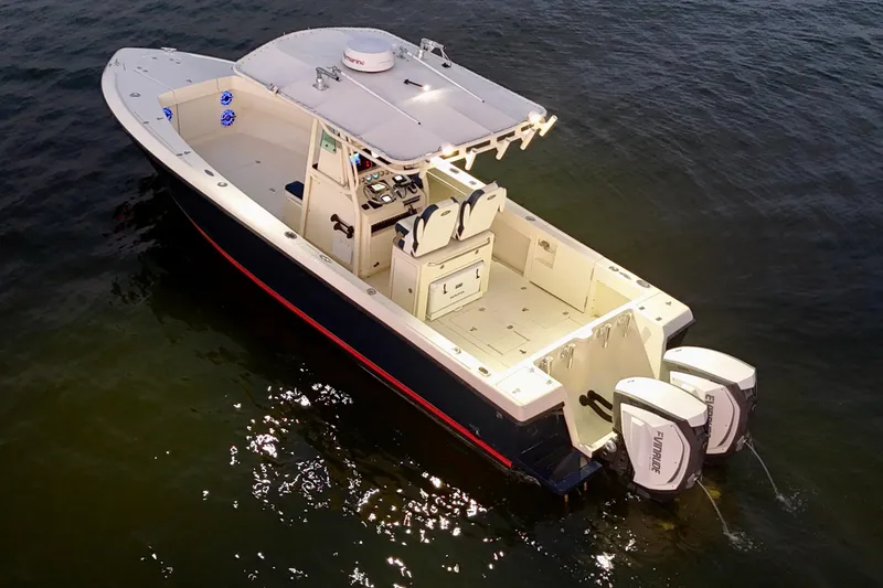 Slide: The Image of 2003 Intrepid 289 Center Console boat on water, featuring dual outboard engines. - 22