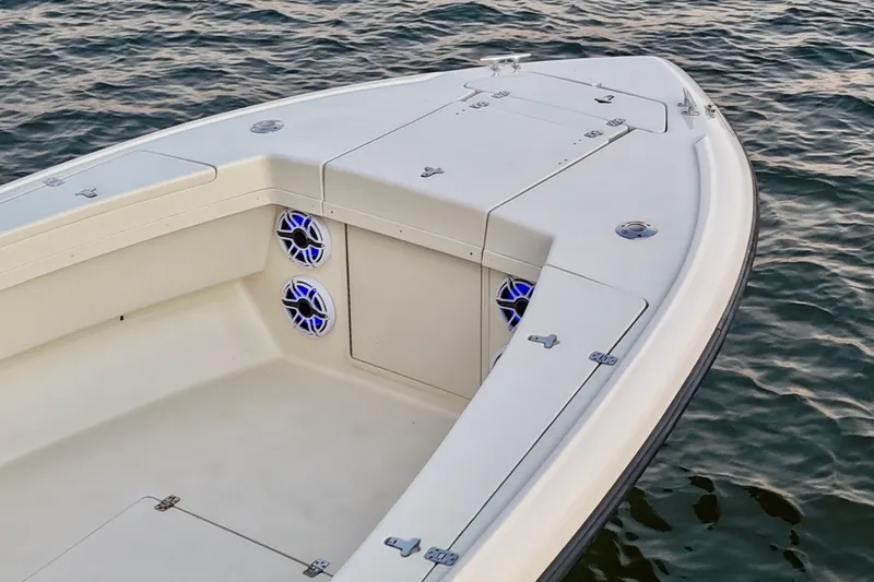 Slide: The Image of 2003 Intrepid 289 Center Console boat on water, featuring sleek design and modern speakers. - 24