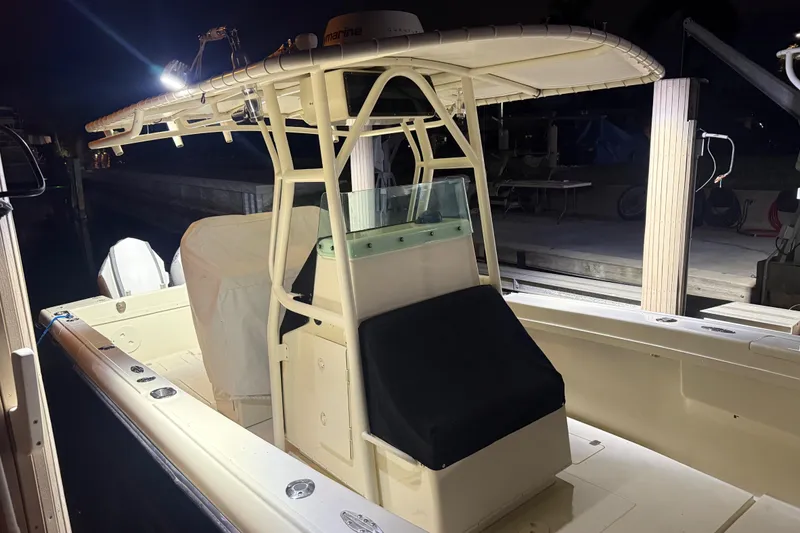 Slide: The Image of 2003 Intrepid 289 Center Console boat at night, docked with illuminated T-top. - 25
