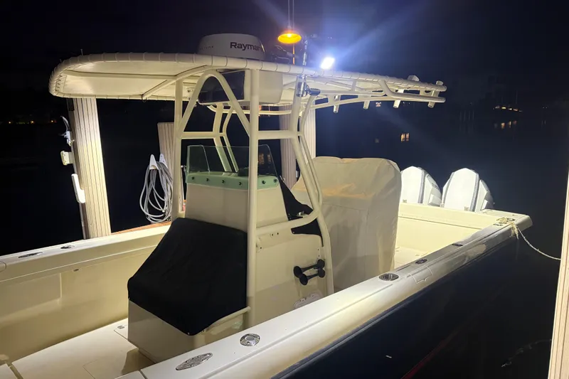 Slide: The Image of 2003 Intrepid 289 Center Console boat illuminated at night, showcasing sleek design and equipment. - 28
