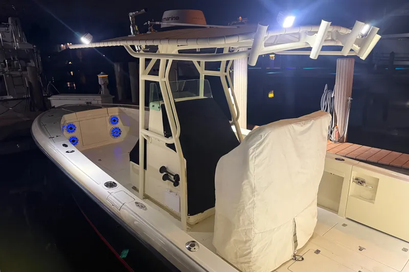 Slide: The Image of 2003 Intrepid 289 Center Console boat illuminated at night, showcasing deck and console features. - 29