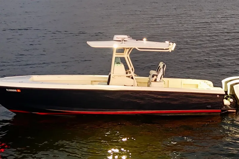 Slide: The Image of 2003 Intrepid 289 Center Console boat on calm water at dusk. - 3