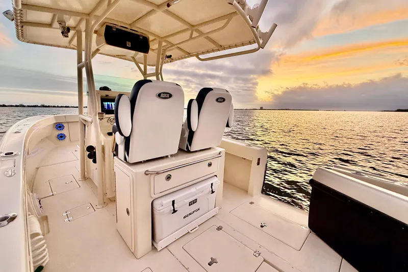 Slide: The Image of 2003 Intrepid 289 Center Console boat at sunset on calm waters. - 32