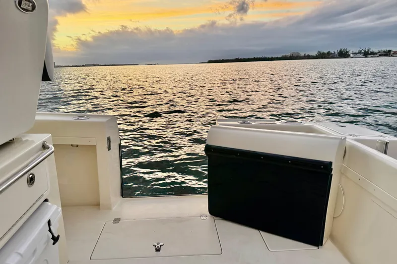 Slide: The Image of 2003 Intrepid 289 Center Console boat at sunset on calm waters. - 35