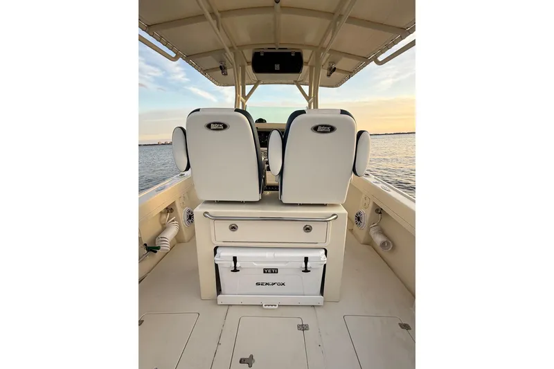 Slide: The Image of 2003 Intrepid 289 Center Console boat interior with dual seats and Yeti cooler. - 38
