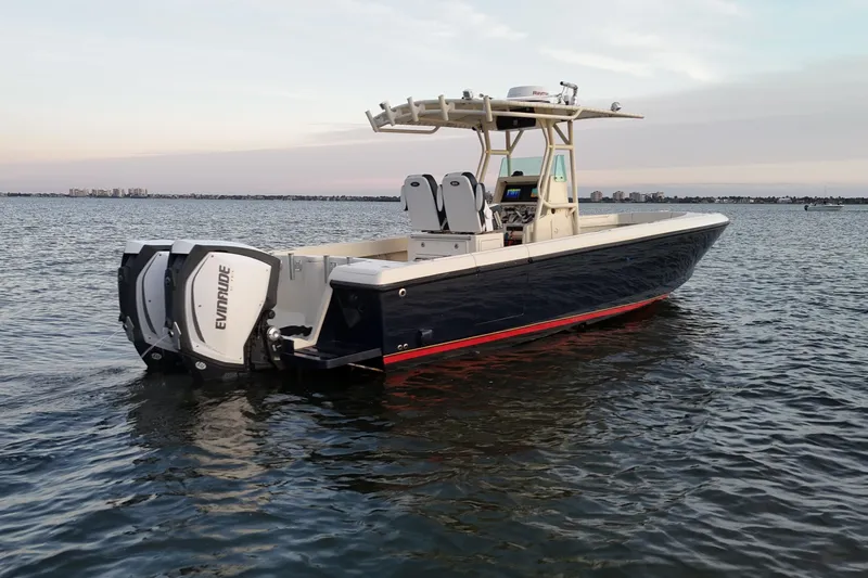 Slide: The Image of 2003 Intrepid 289 Center Console boat on calm water at sunset. - 4