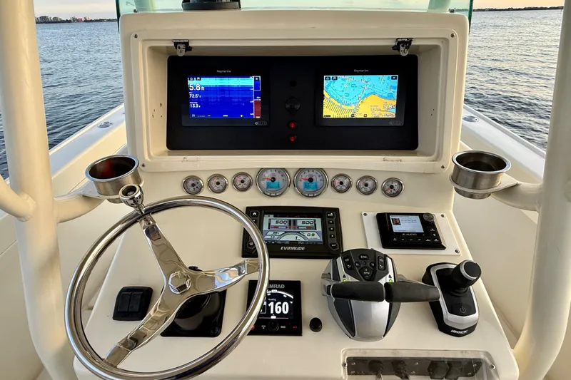 Slide: The Image of Center console of 2003 Intrepid 289 boat with navigation screens and controls. - 42